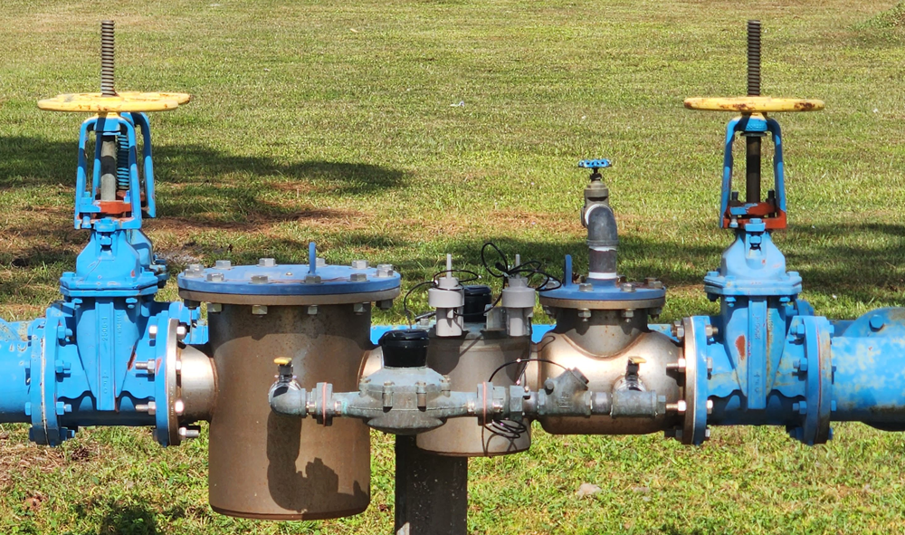 Pipe from water main pipe line in, near sewer, and backflow prevention plumbing valve testing